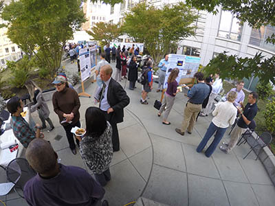 Fair visitors talk with graduate students about their reserve-based research.